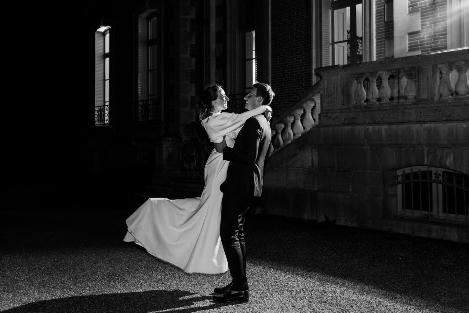 Mariage Marion et guillaume : couple de mariés en train de danser, photo en noir et blanc Château de la baronnie